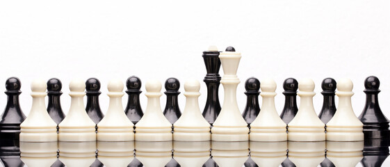 Black and White Chess Pieces Standing in Row. Symmetrical lineup of white and black chess pieces on...