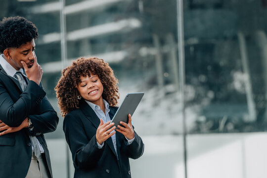 executive presenting her project with a tablet, business people