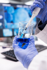 Close up of expert in lab extracting matter from a jar with pipette to mix bio samples and tissue. Experiment with element preparation showcasing precision in science and molecular biology.