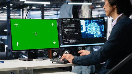 Data center technician uses machine learning algorithms on isolated screen PC to analyze datasets. Server hub worker uses AI neural networks on chroma key computer to recognize data patterns, camera A