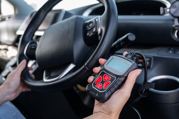 Woman using OBD2 diagnostic scanner. 