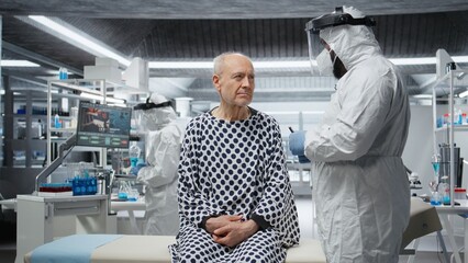 Black medic in quarantine facility provides medical care to patient during outbreak, collecting...