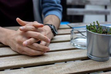 Man hands holding coffee cup and stirring sugar