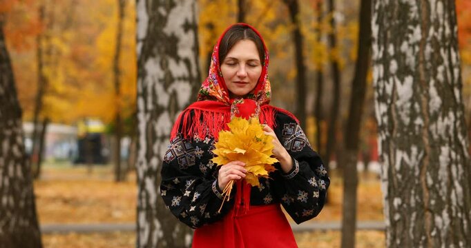 Young beautiful woman in a headscarf in an autumn park
