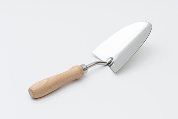 Small garden trowel. A metal trowel with a wooden handle, ideal for digging, planting, and removing weeds, characterized by its sturdy construction and ergonomic design for efficient gardening tasks.