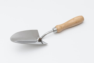 Small garden trowel. A metal trowel with a wooden handle, ideal for digging, planting, and removing weeds, characterized by its sturdy construction and ergonomic design for efficient gardening tasks.