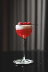 Elegant Raspberry Cocktail with Foam and Fresh Berry Garnish