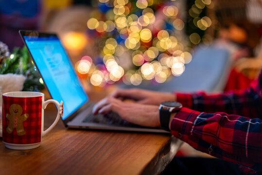 Working on a laptop with a festive mug during the Christmas holiday season