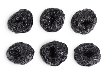 Prunes isolated on white background, heap of dried plums. Top view. Flat lay