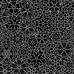 Floral black and white pattern on a black background, abstract design, seamless background.