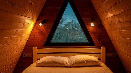 Cozy bedroom interior with a triangular window and wooden walls