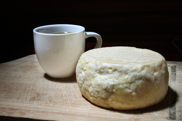 Cup of brazilian coffee and traditional cheese.