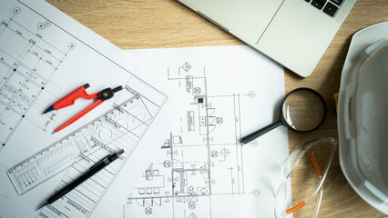A drawing of a building with a magnifying glass and a pair of safety glasses on top of it