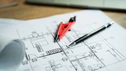 A red and black pencil sits on top of a piece of paper with a ruler and a protractor. Concept of precision and attention to detail, as the tools are used to create accurate measurements and drawings