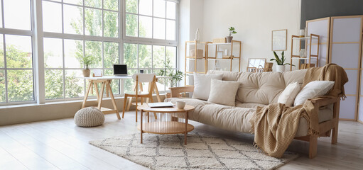 Interior of modern light living room with sofa and table