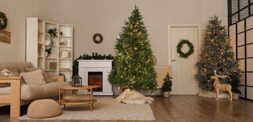 Christmas trees, wreaths and fireplace in interior of living room