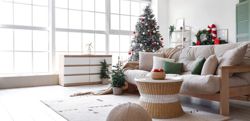 Interior of living room with white sofa, Christmas trees and festive decorations
