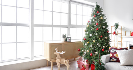 Interior of living room with Christmas tree, gift boxes, wooden reindeer and festive decorations