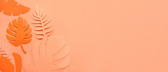 Different tropical leaves on orange background