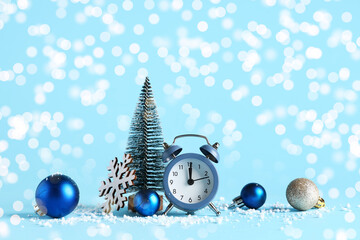 Alarm clock with Christmas decor on blue background