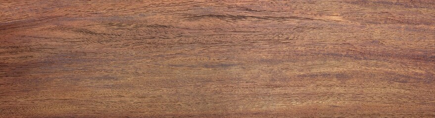 Vintage padauk wood (Pterocarpus soyauxii)  wood texture, in wide format. Raw unfinished surface. Strong, stable hardwoods known for their reddish-brown coloration, which darkens and fades with age.