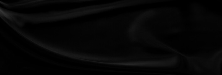 Black gray satin dark fabric texture luxurious shiny that is abstract silk cloth panorama background with patterns soft waves blur beautiful.