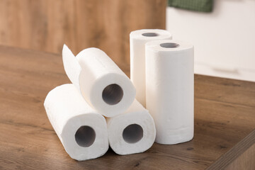 Rolls of paper towels on table in kitchen