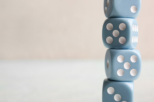 Stack of blue dices on light background
