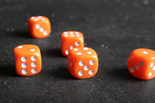 Orange dices on dark background