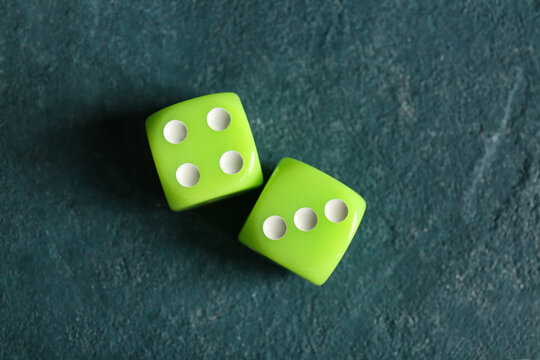 Green dices on color background