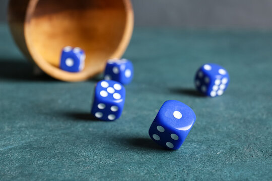 Scattered blue dices on color background
