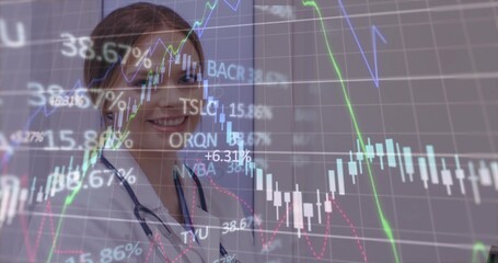 Standing doctor wearing lab coat and stethoscope analyzing financial overlay in clinic, copy space