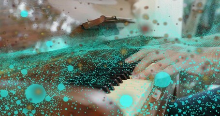Pianist's hands pressing wooden grand piano keys in studio, with turquoise digital particles