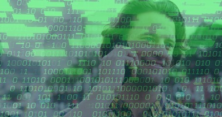 IT professional in checkered shirt talking on smartphone in office, with binary overlay, copy space