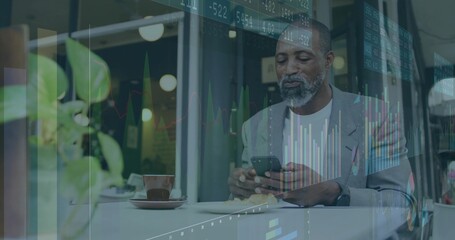 Fototapeta premium Analyzing financial charts, male professional holding smartphone at coffee shop, with coffee cup