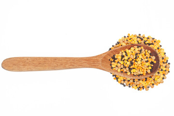 Wooden kitchen spoon filled with mixed lentils isolated on white
