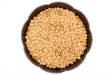 Top view of lentil seeds in black plate on white background”