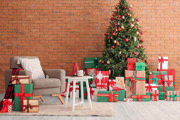 Interior of living room with Christmas tree, presents and armchair