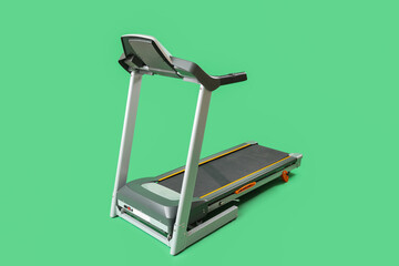 Modern treadmill on green background