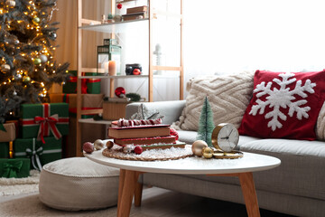 Books with Christmas decor and snow on table in living room