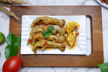 a plate of Spicy food, ceker mercon. Selective focus. Chicken feet with spicy chili sauce or ceker mercon. Ceker pedas or spicy chicken feet. Indonesian street food made from chicken feet, chili, 