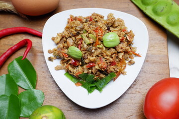 Pampis Tongkol or Cakalang, Manado's Traditional Seafood Dish of Spicy Shredded Fish, Served on White Plate with chilli, onion, garlic and tomato
