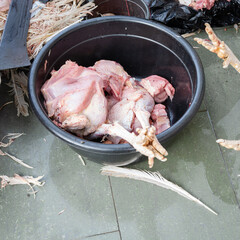 A raw turkey being butchered, a thanksgiving turkey being prepared for cooking, process of butchering an organic turkey