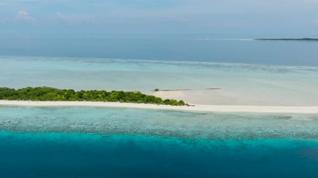 Aerial drone of sandy tropical island with a beautiful beach surrounded by a coral reef. Timba Timba islet. Tun Sakaran Marine Park. Borneo, Sabah, Malaysia.
