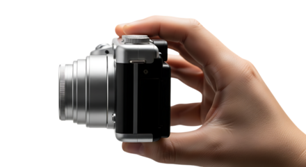hand holding a silver digital camera with a textured lens and silver top dial, cutout, PNG isolated on white or transparent background