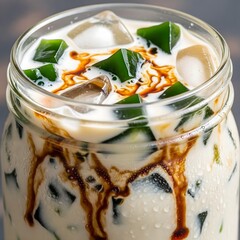 Traditional Indonesian iced grass jelly drink with coconut milk and palm sugar syrup.
