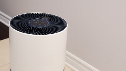 Sleek Modern Tall Air Purifier with Black Fan on Beige Tile Floor in Stylish Room