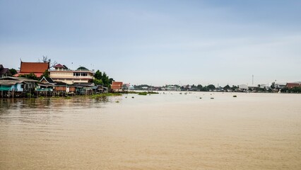 Fototapeta premium Reflection of Nature: A Scenic Journey Along the River Banks of the City After the Flood Under a Vibrant Sky