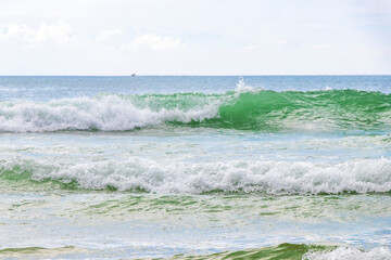 Waves turquoise blue water and sand at tropical beach Thailand.