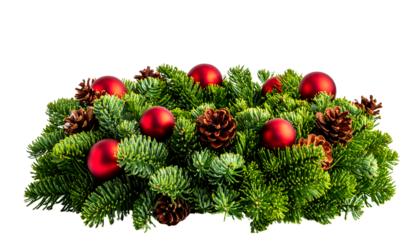 Christmas centerpiece of green fir branches, red ornaments, and pine cones, isolated on white